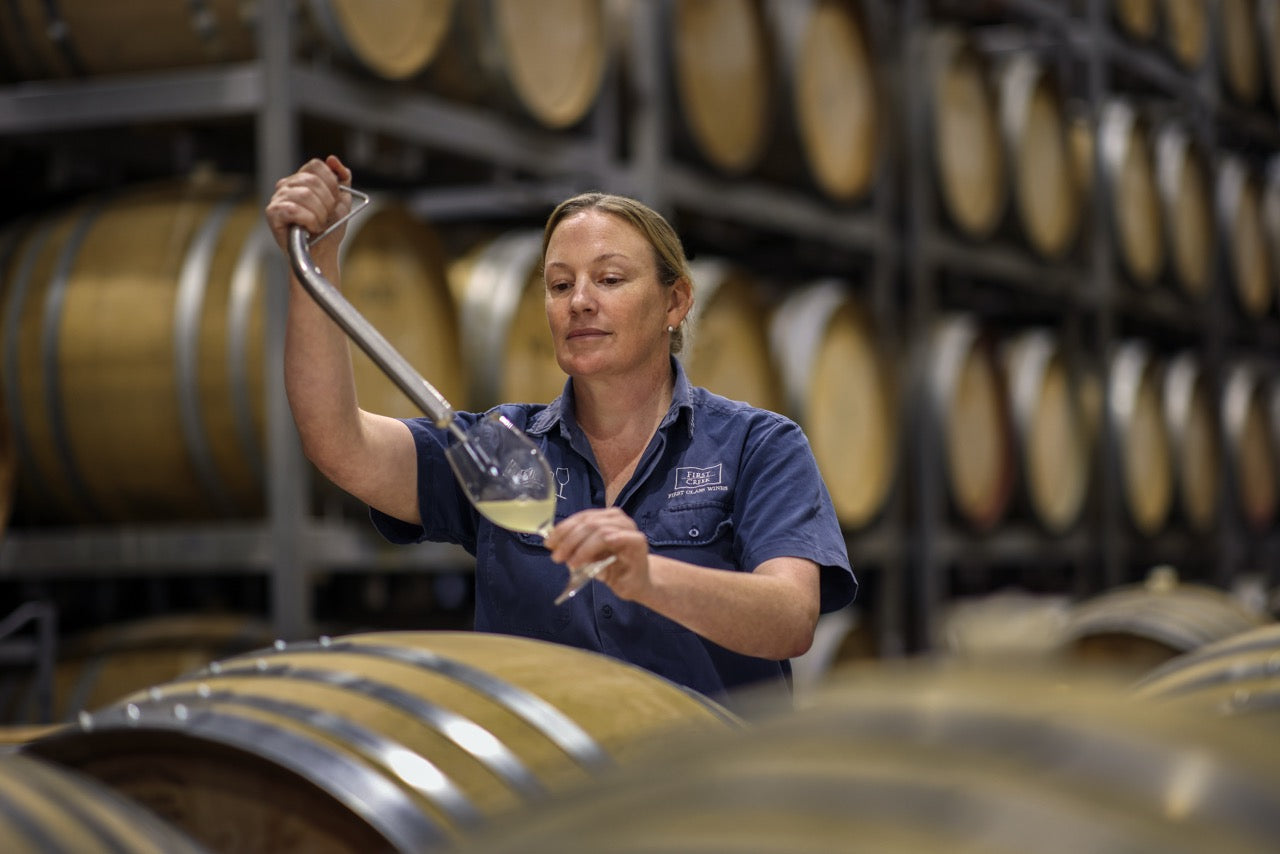 Liz Silkman drawing a barrel sample in the winery, Photo by Elfes Images