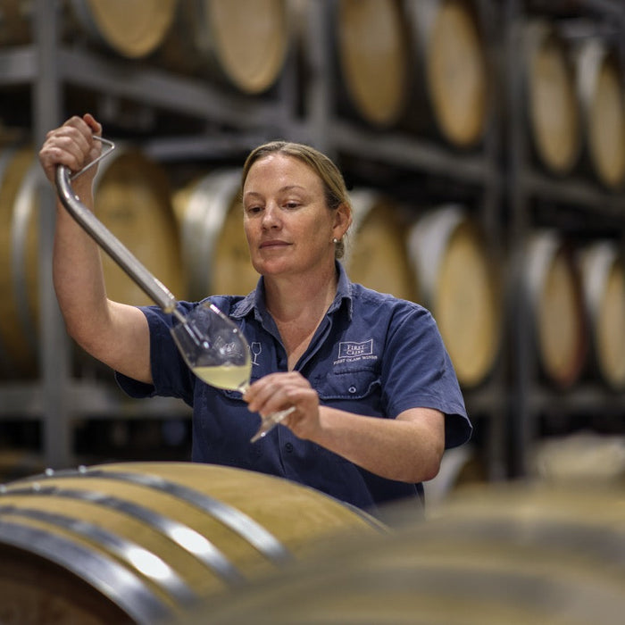 Liz Silkman drawing a barrel sample in the winery, Photo by Elfes Images
